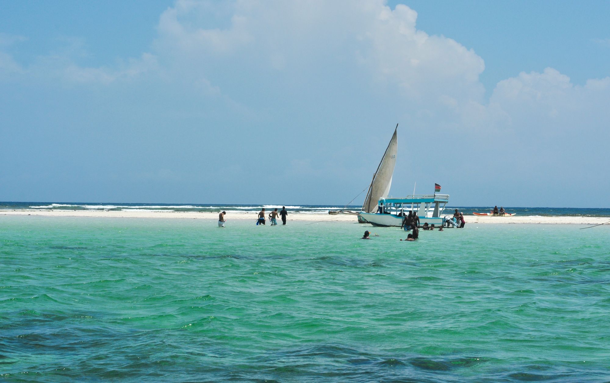 A dhow under sail on turquoise water